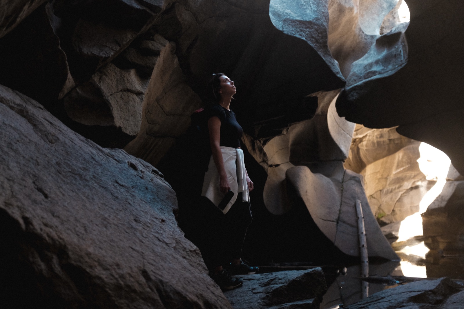 Woman exploring cave rock formation