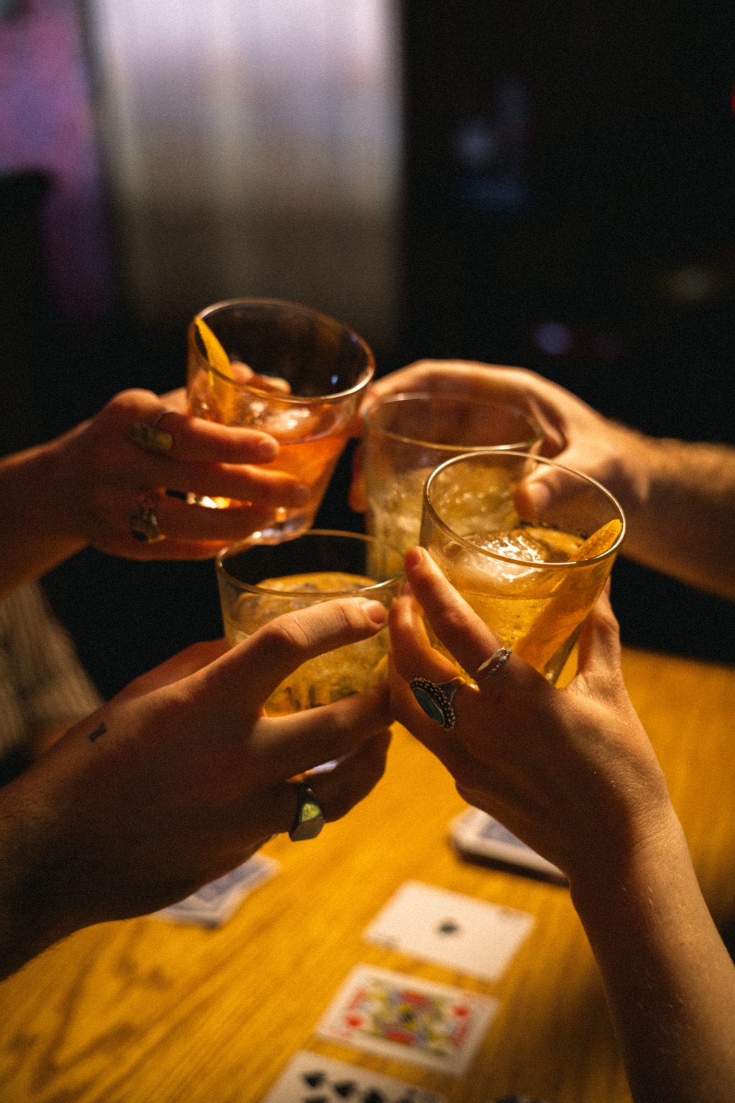 Friends cheers — warm bar lighting