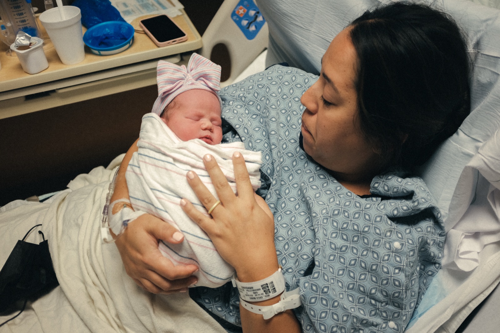 Mother holding newborn — hospital birth moment