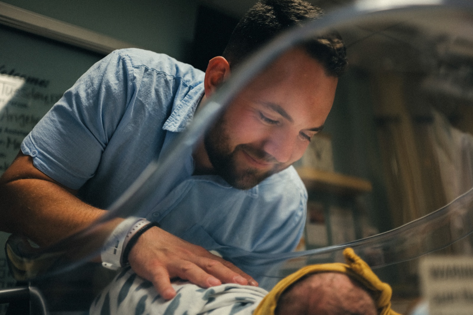 Father gazing at newborn — hospital moment