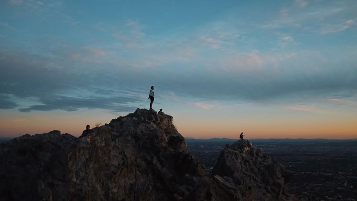 Silhouette on mountain peak at sunset