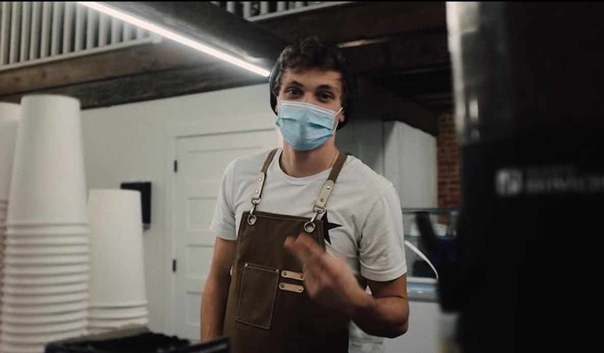 Barista in mask — behind the counter