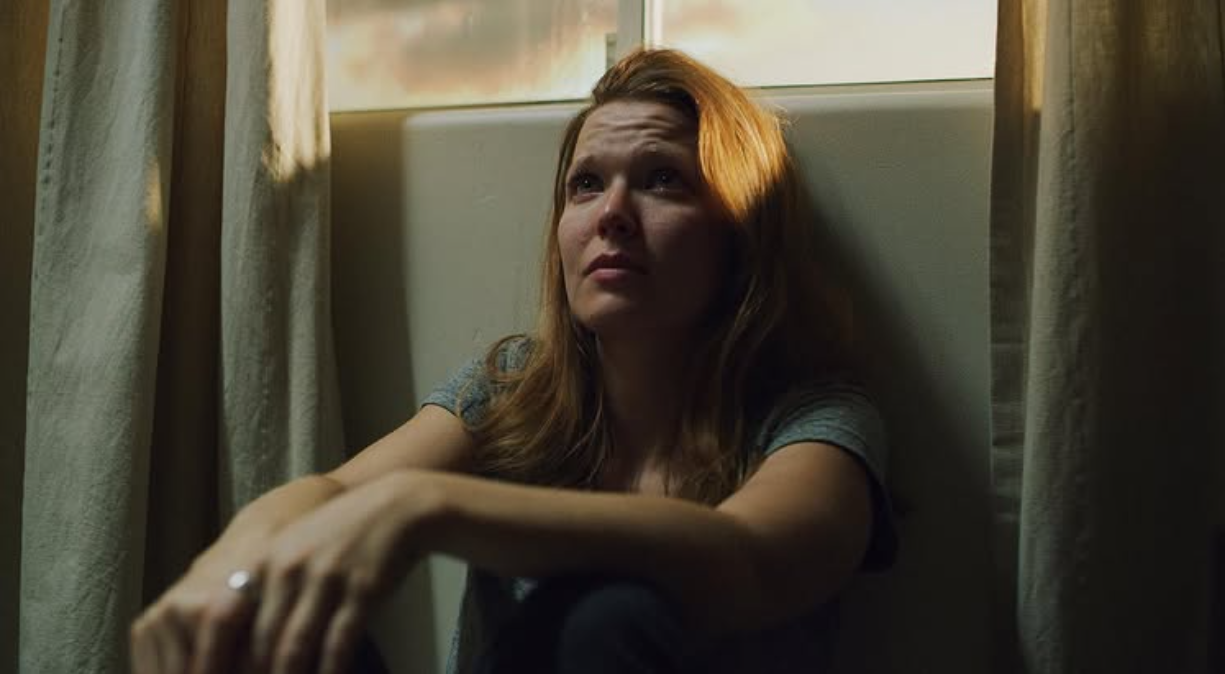 Woman by window — dramatic golden light